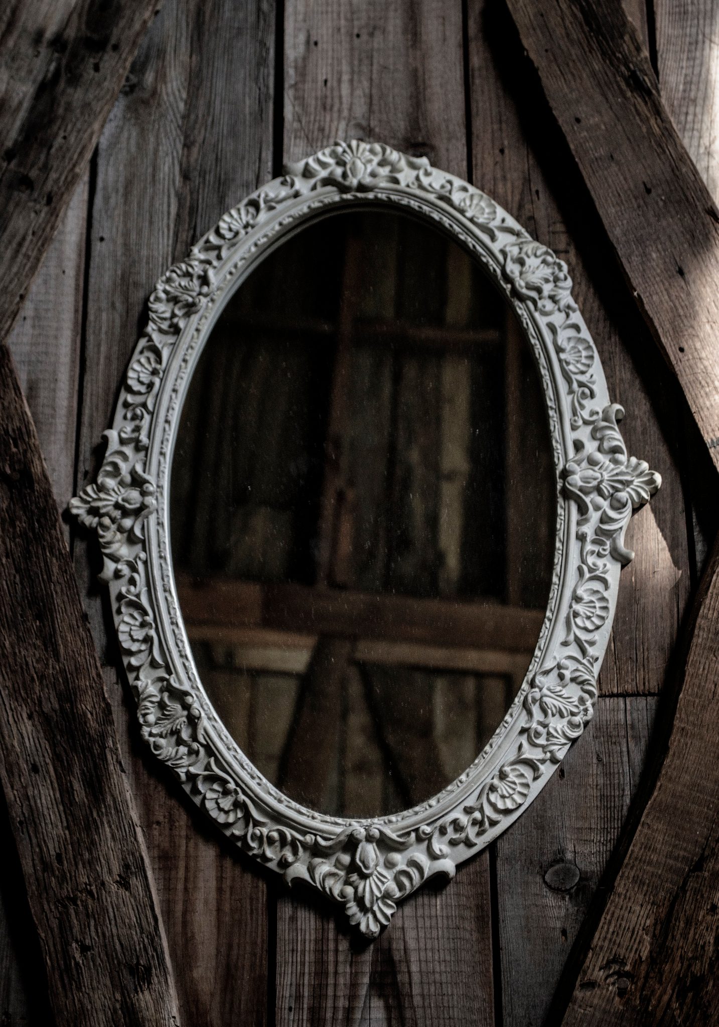 An ornate empty frame hangs on the barn wall, framing only the weathered boards. We make meaning where there simply is none.