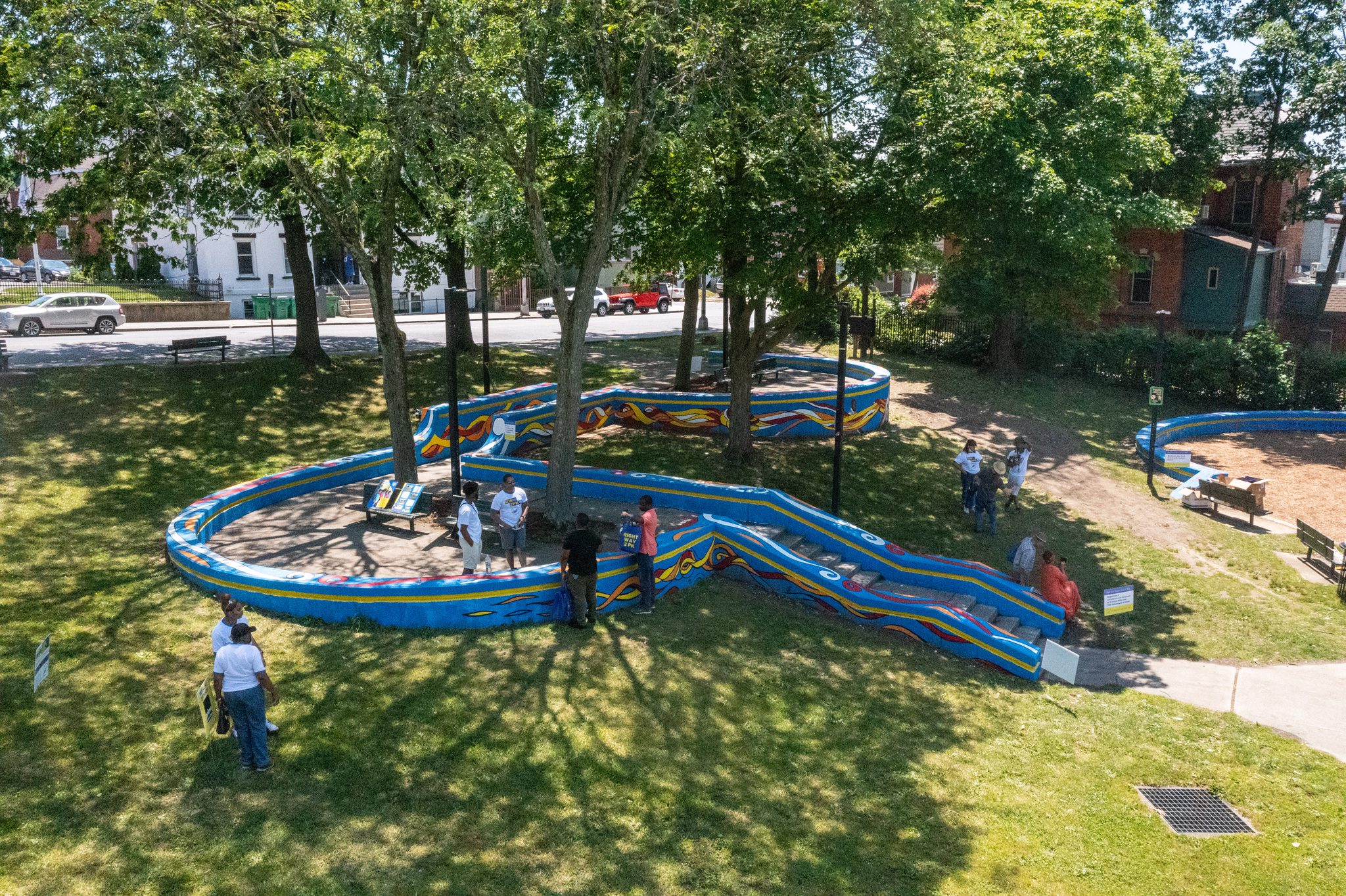 The newly painted wall loops through the park in blue, yellow and red.