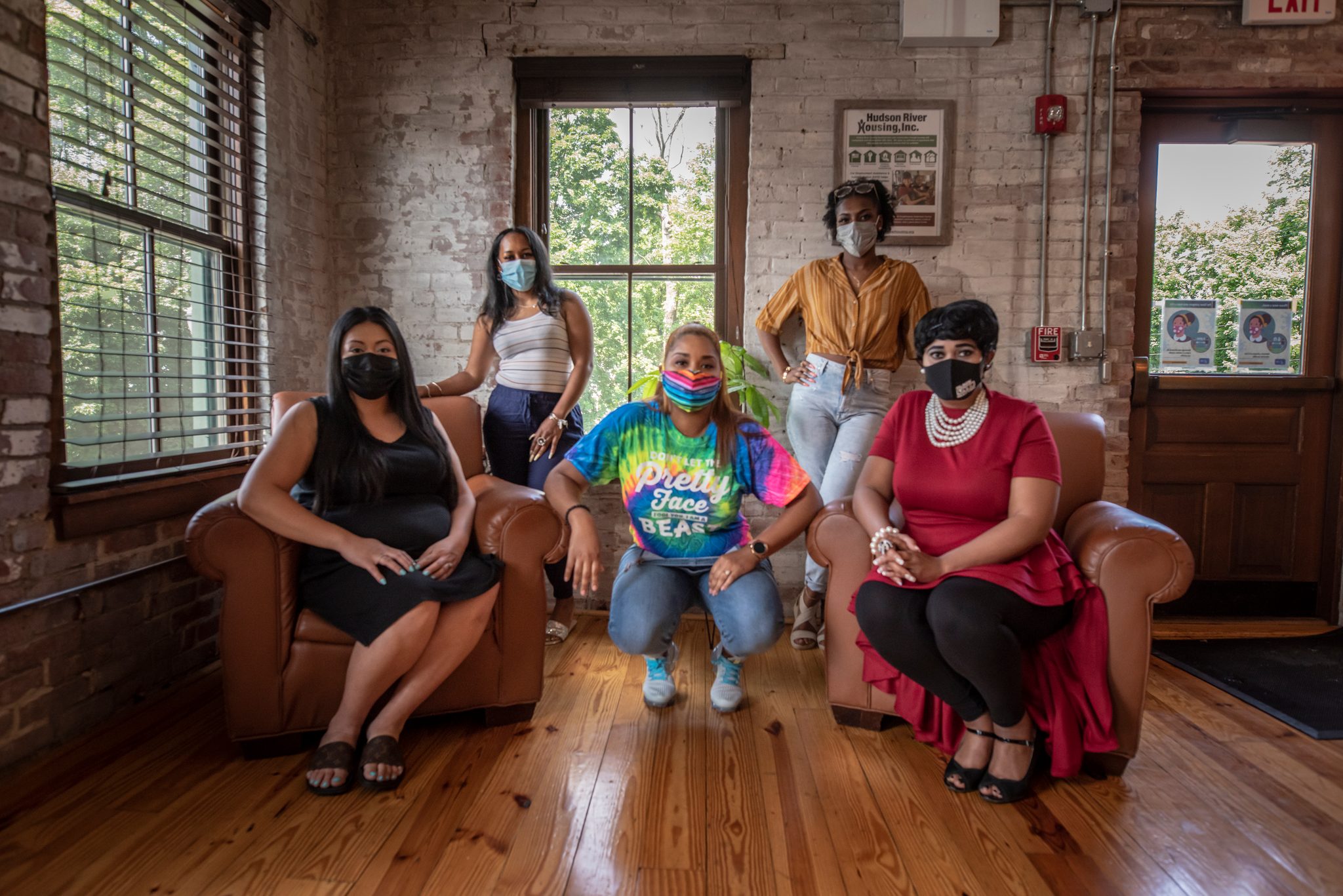 Mothers gather in a sunlit brick room for the conversation.