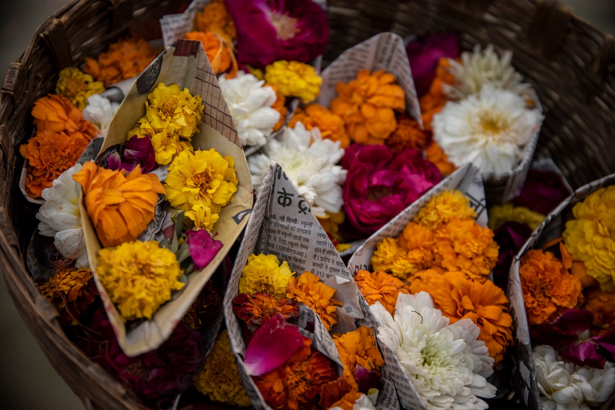A basket of paper boats filled with Pooja offerings to be sent down the river
