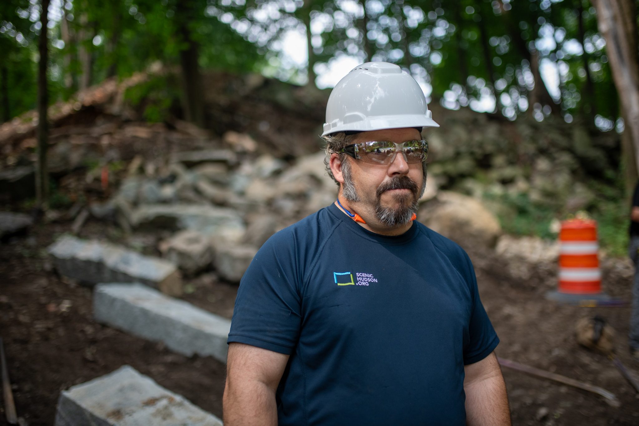 A bearded crewman stands among the new steps, safety glasses on.
