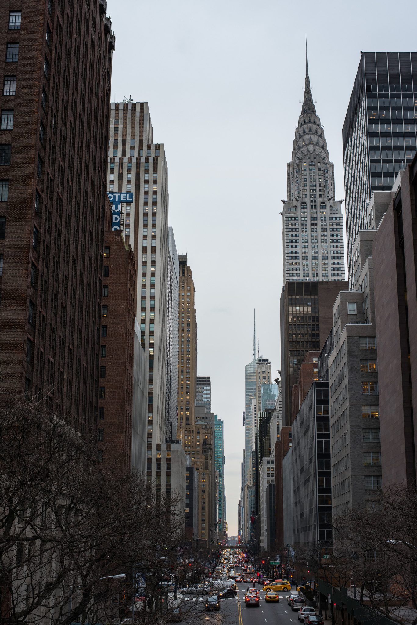 The Chrysler Building crowns the canyon of towers, taxis streaming along below.