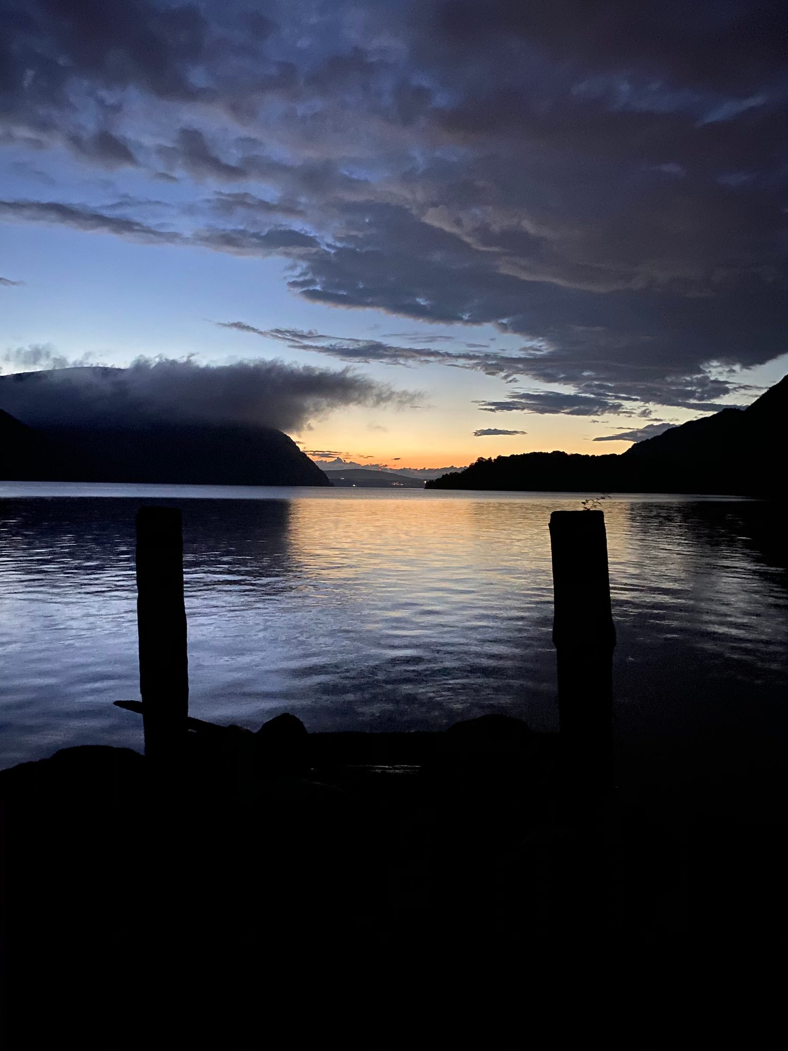 Pilings black against the last light over the Highlands.