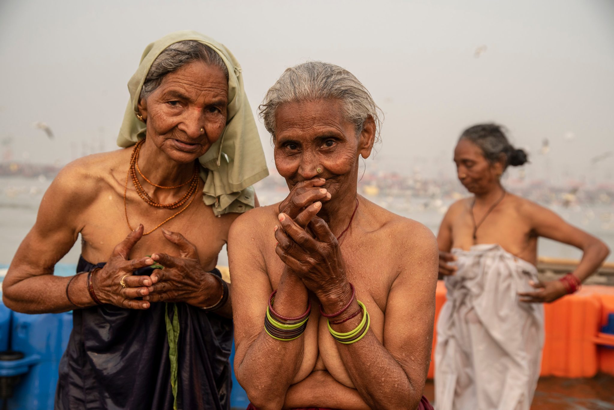 Elder women bathe in the Ganges