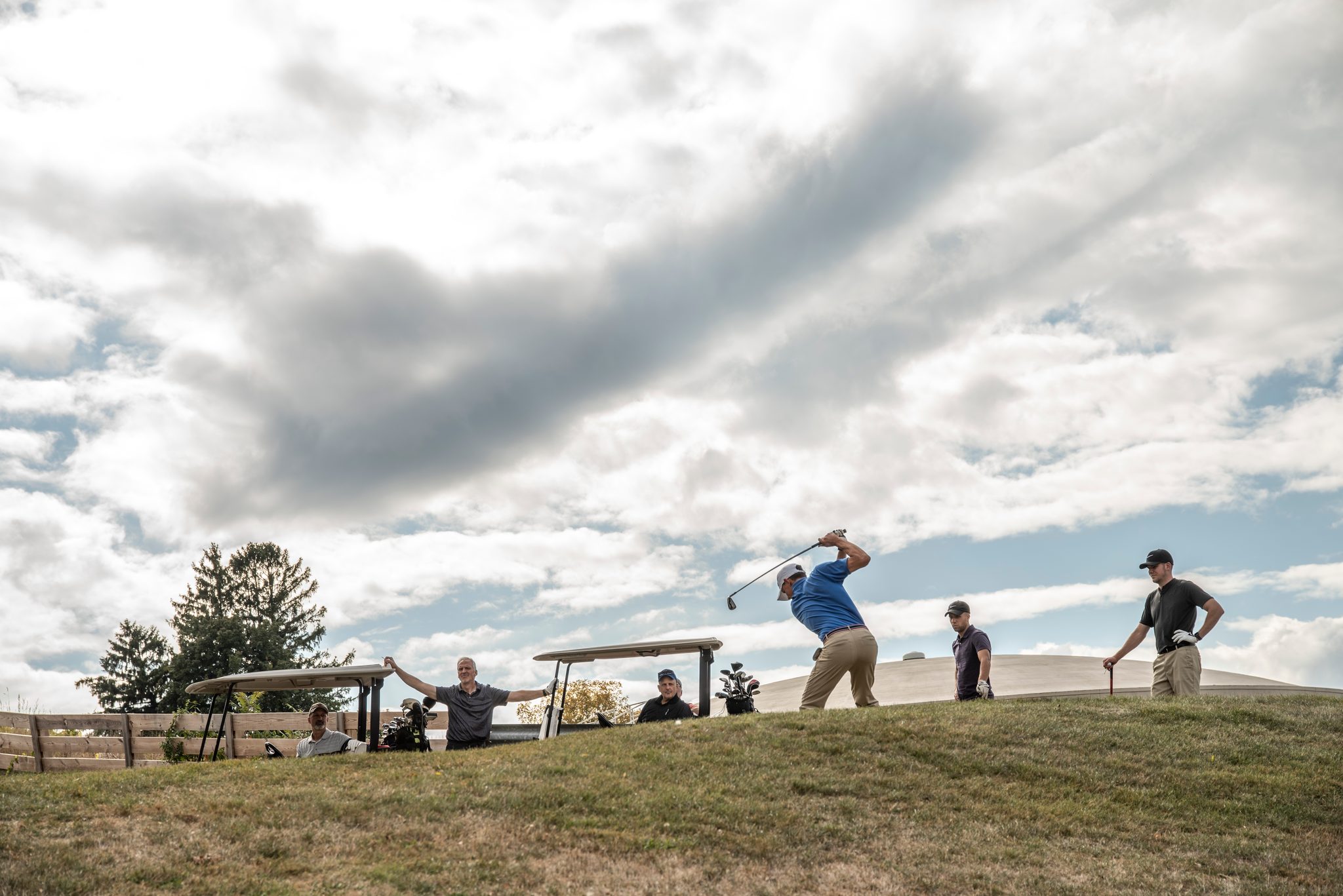 A tee shot against a sky full of clouds.