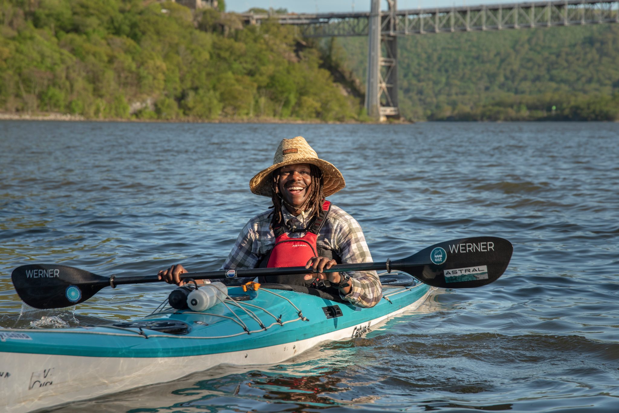 Chev grins from the cockpit with the paddle across his knees and the bridge strung high behind him.