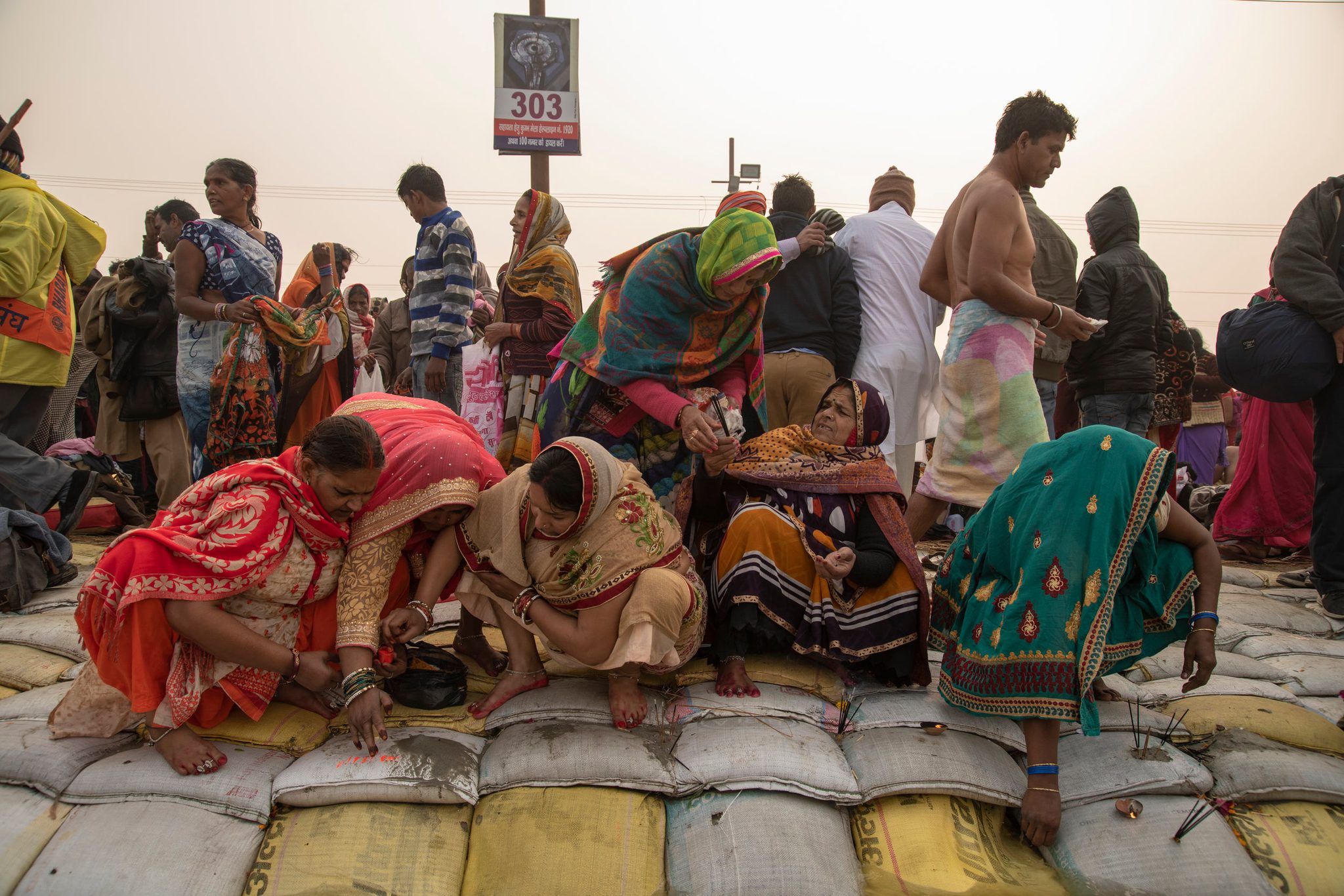 Women gather along the shore of the Ganges to give puja offerings