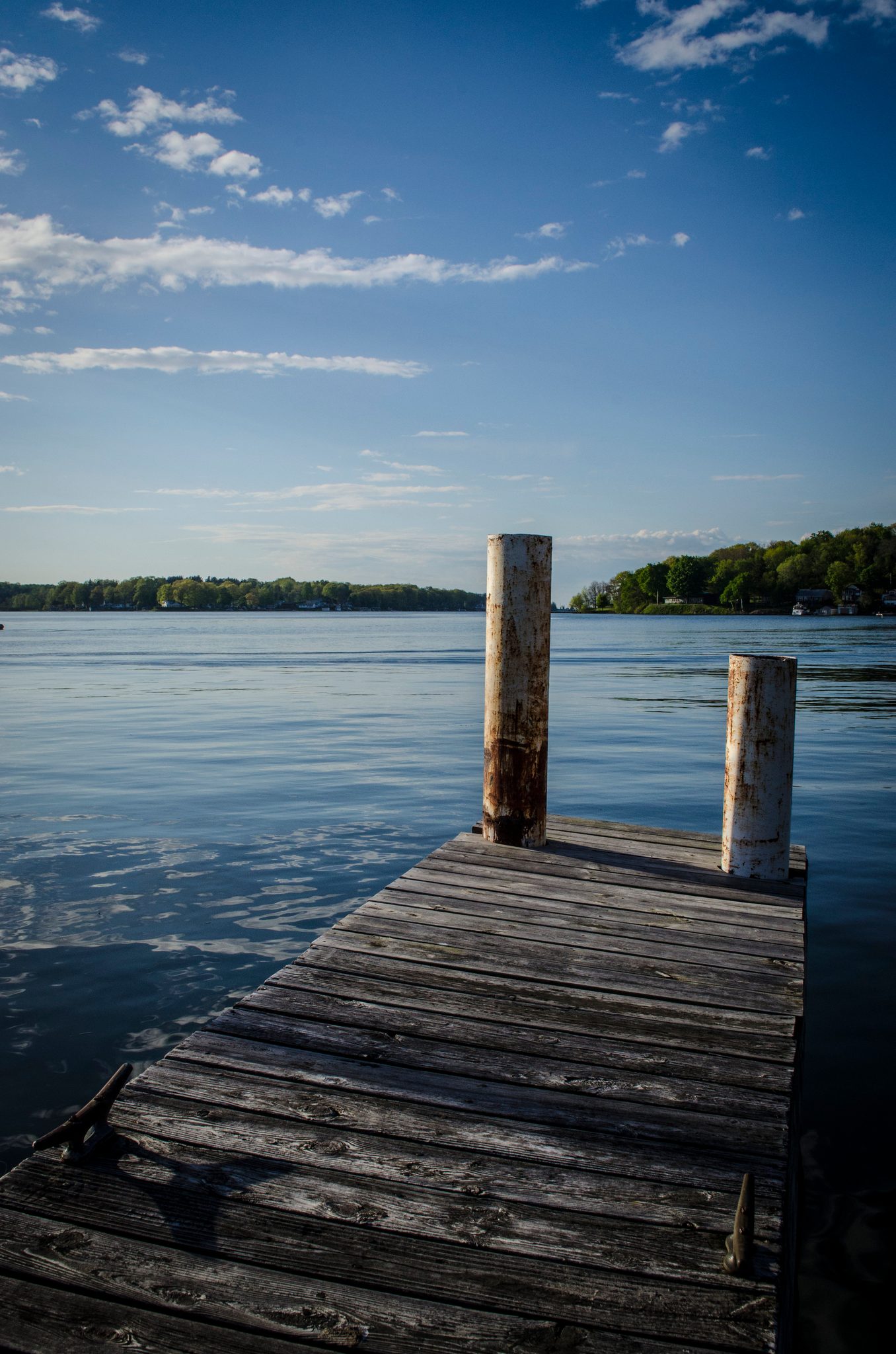 A weathered dock reaches out toward the blue water.