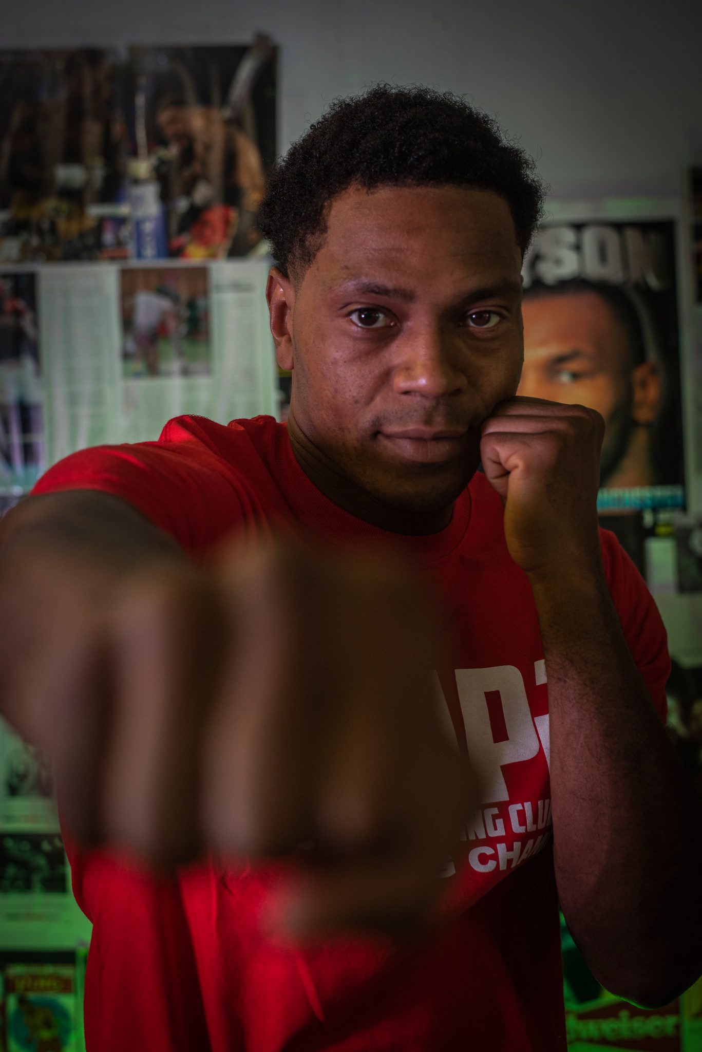 The same fighter throws a jab straight at the lens, his other fist tucked against his cheek.