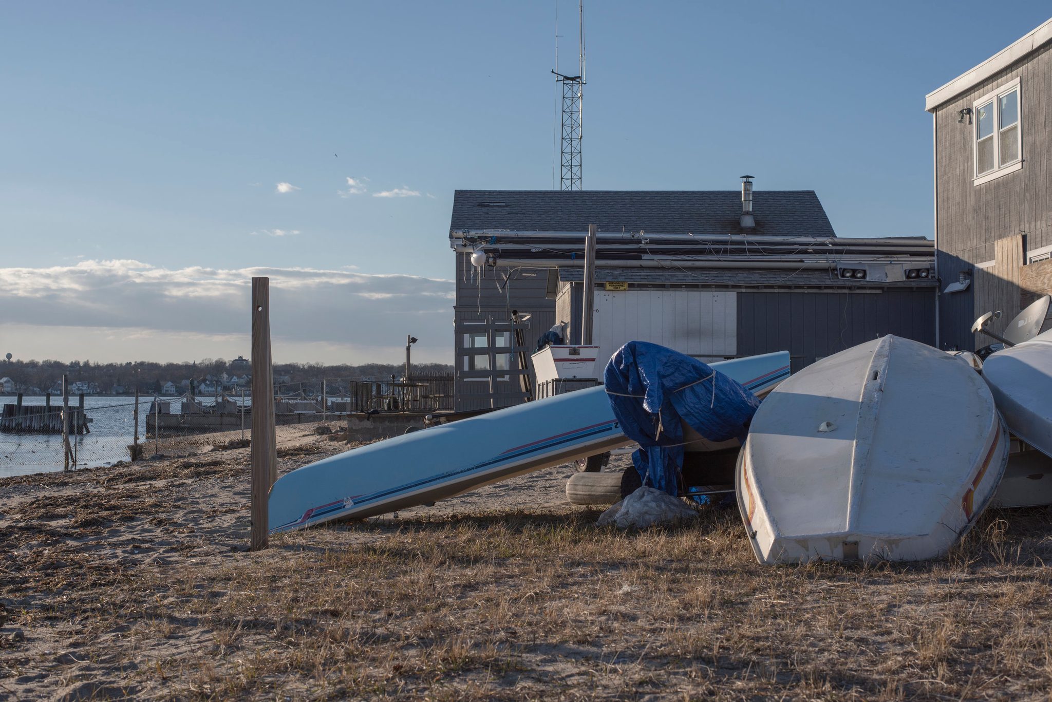 Upturned boats wait out the winter on the sand beside the boatyard.
