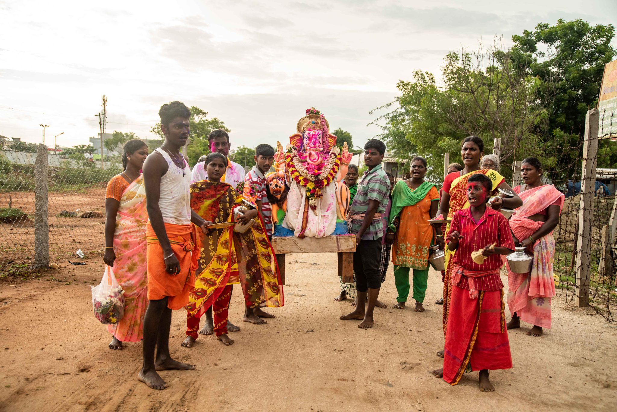 Families gather around the Ganesha idol for its journey.