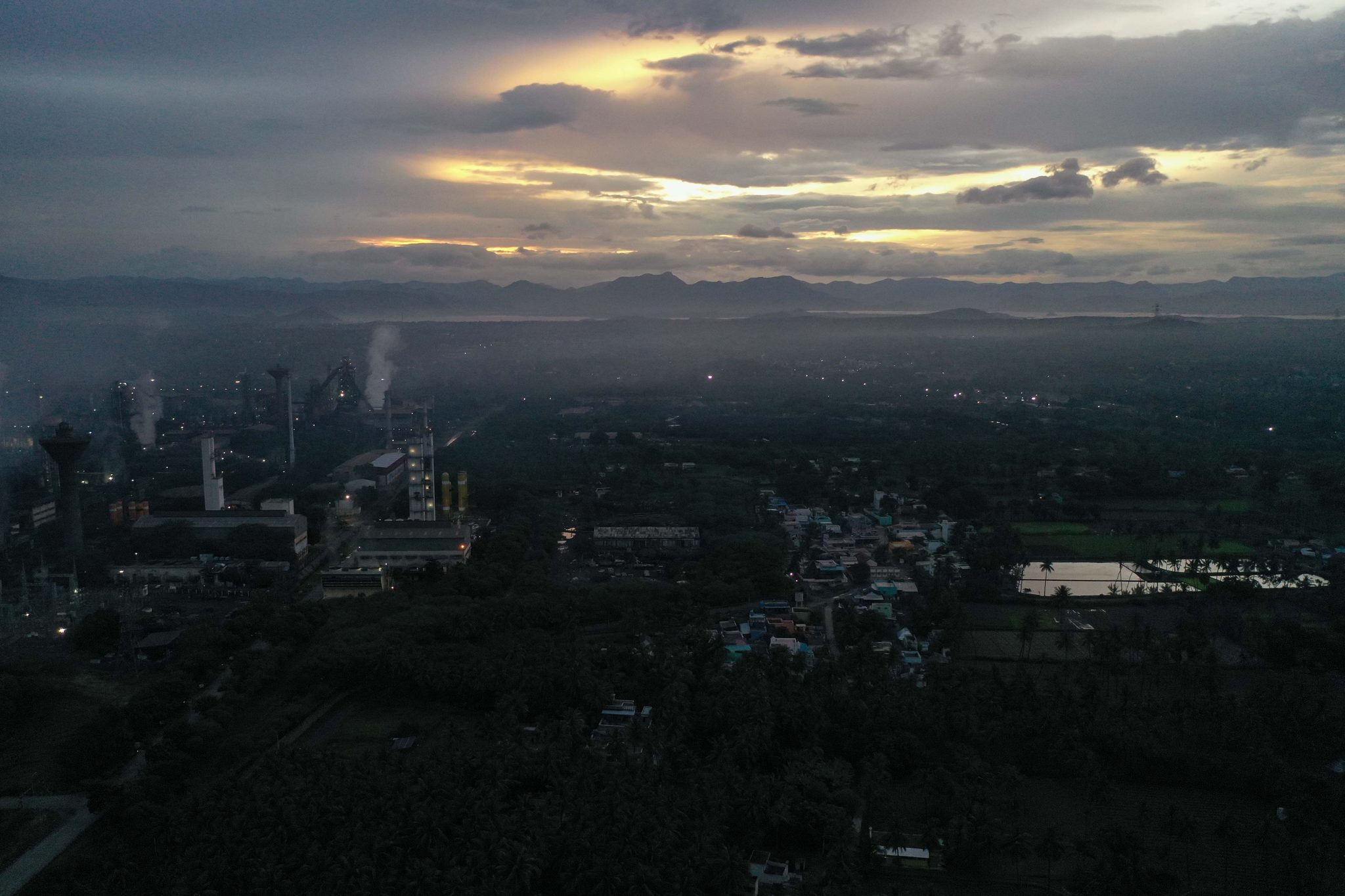First light cuts through the clouds over the mill and the hills beyond.