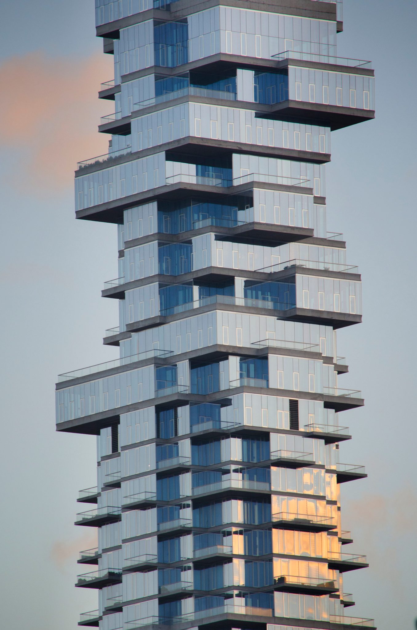 A tower of glass boxes stacked askew, like a game of Jenga paused mid-turn.