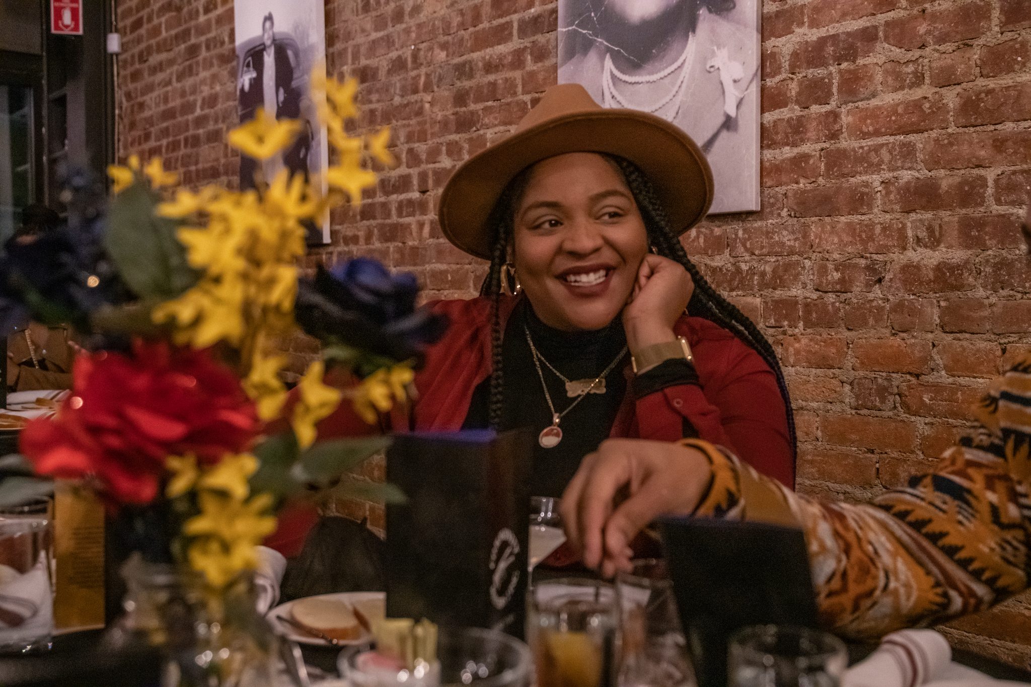 A smile behind the flowers at the dinner table.
