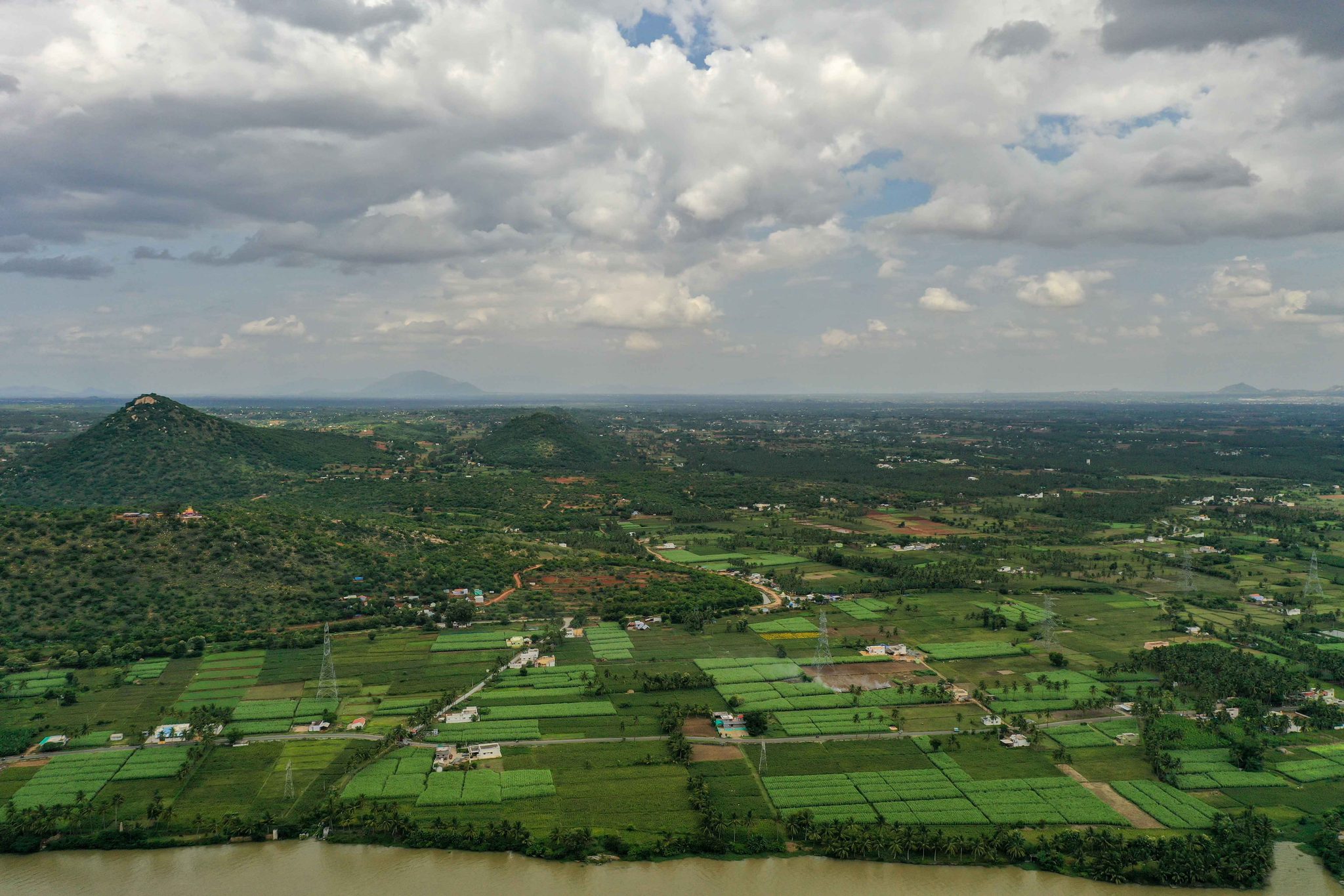 Fields and palms spread across the valley toward a distant range.