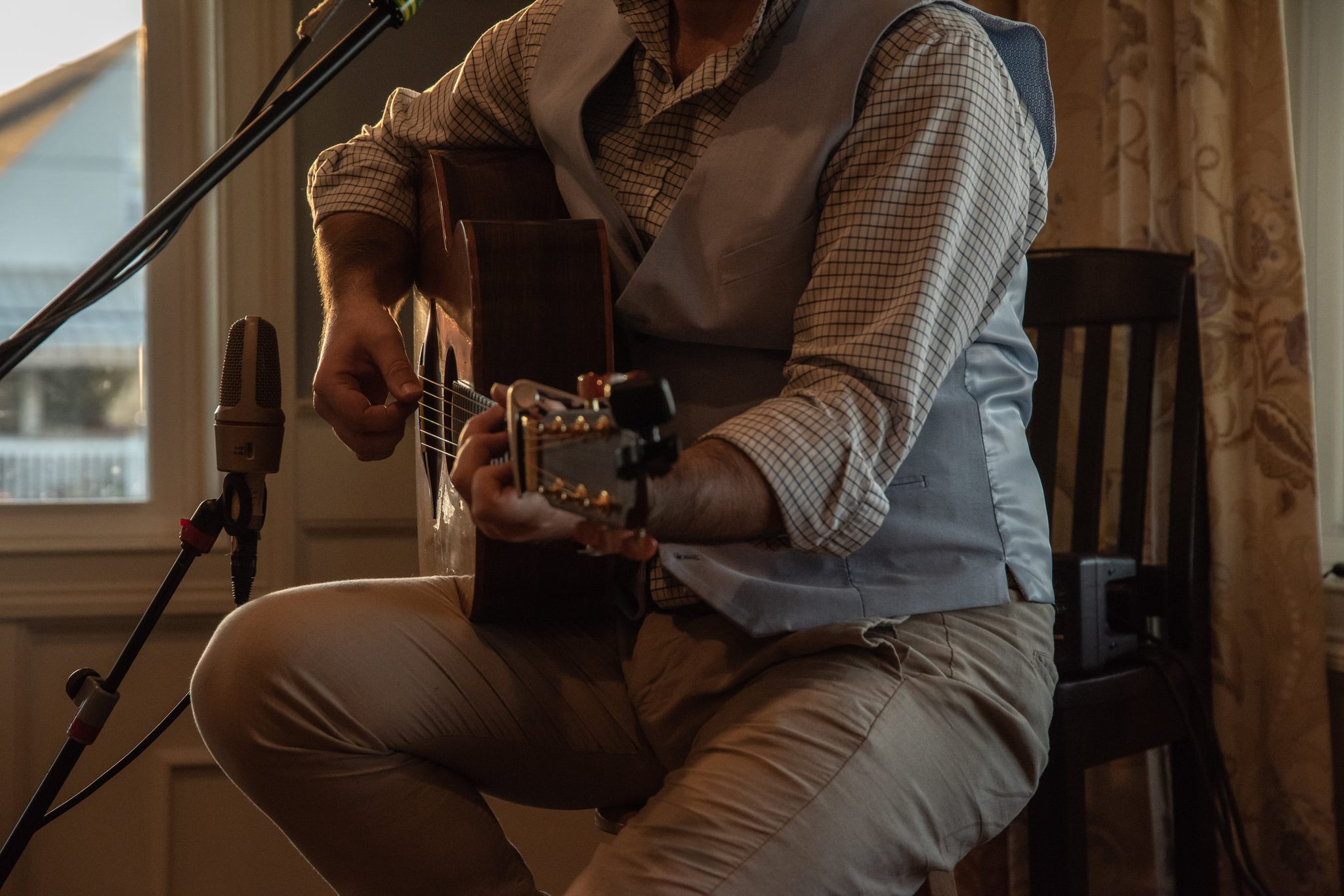 Back on guitar, Emmet strums from his stool as the light goes gold.