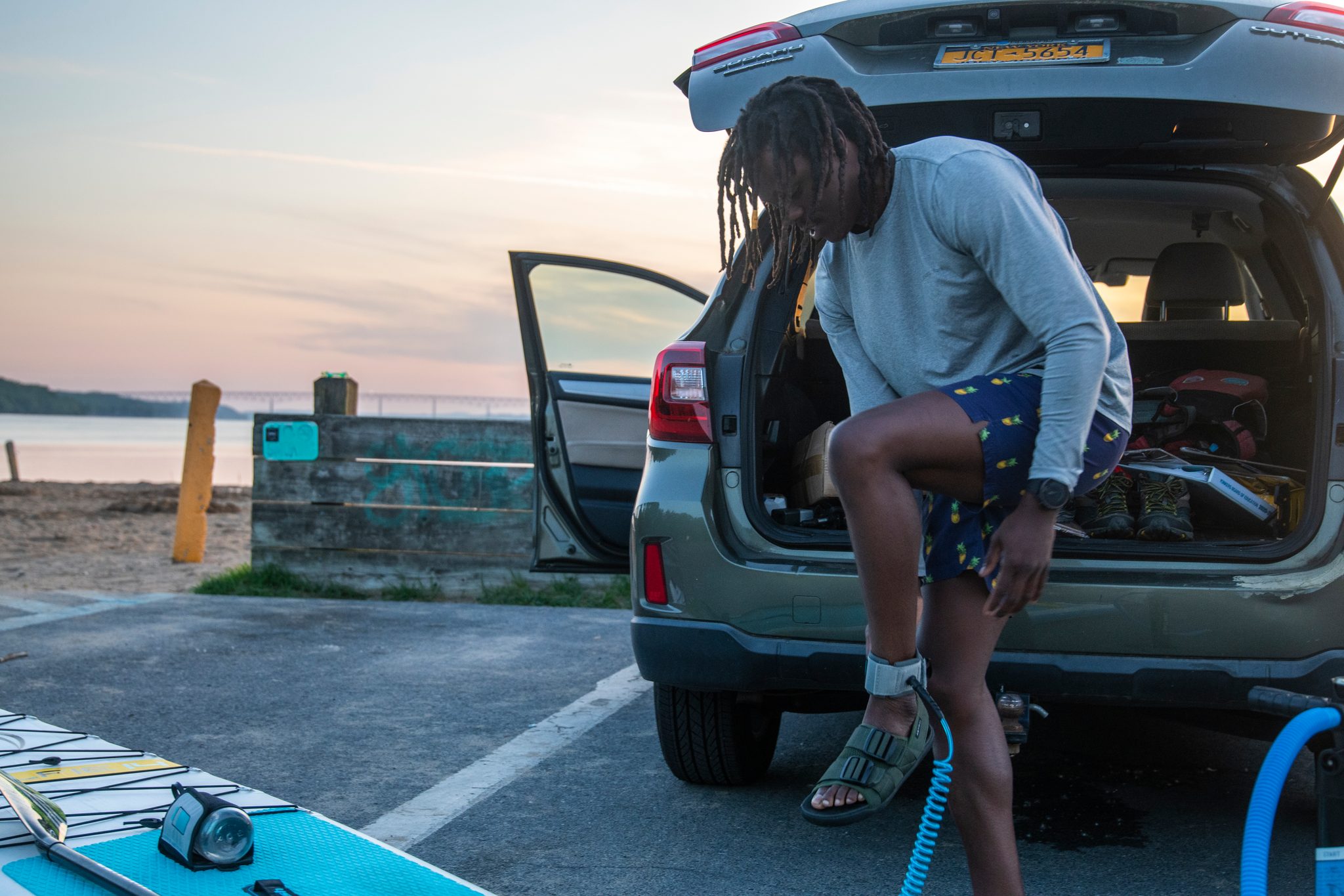 Hatch up, pump hose on the pavement, Chev gets the board ready in the half light.