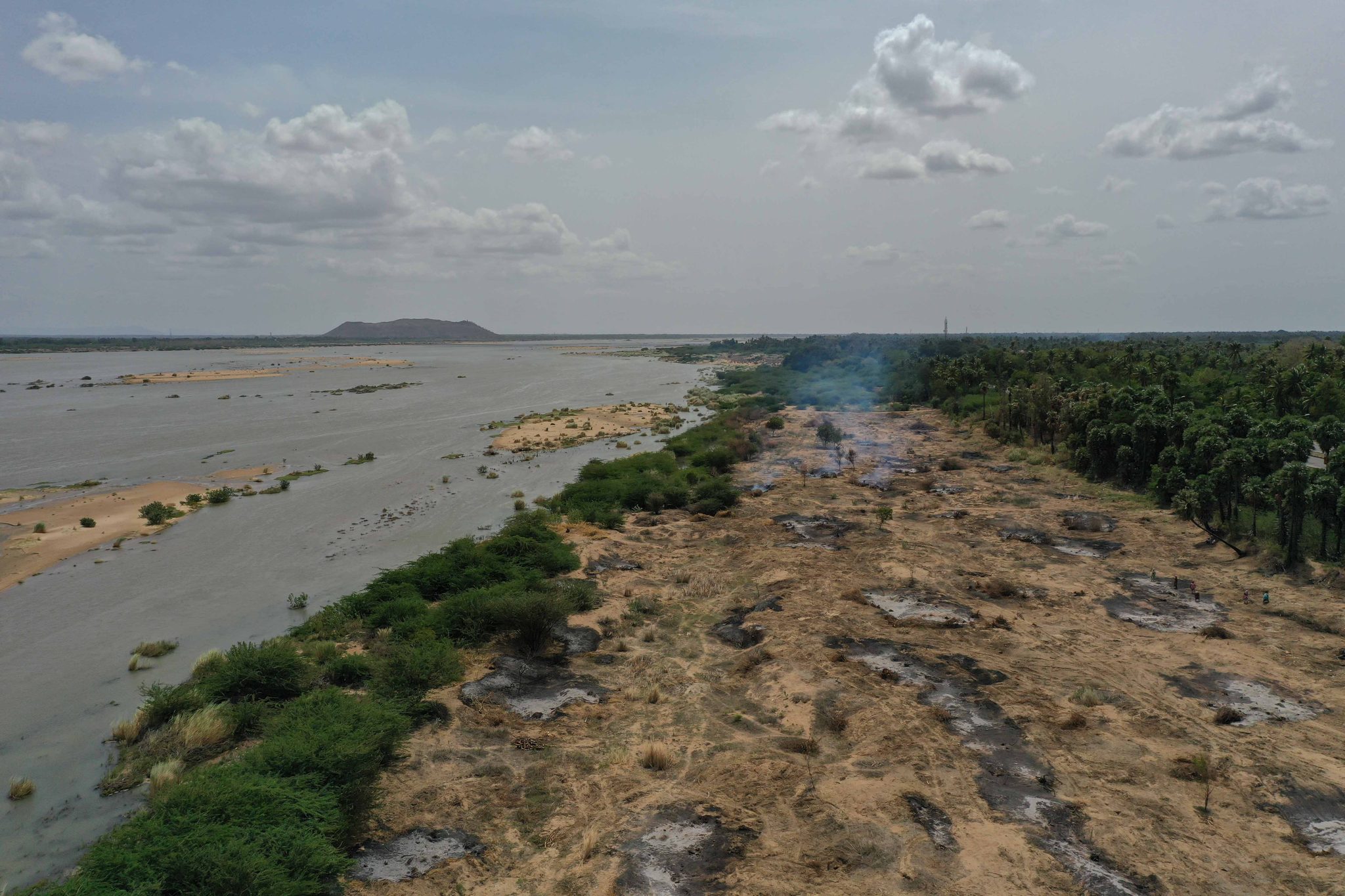 The riverbed lies scarred and bare, the water pushed to one side.
