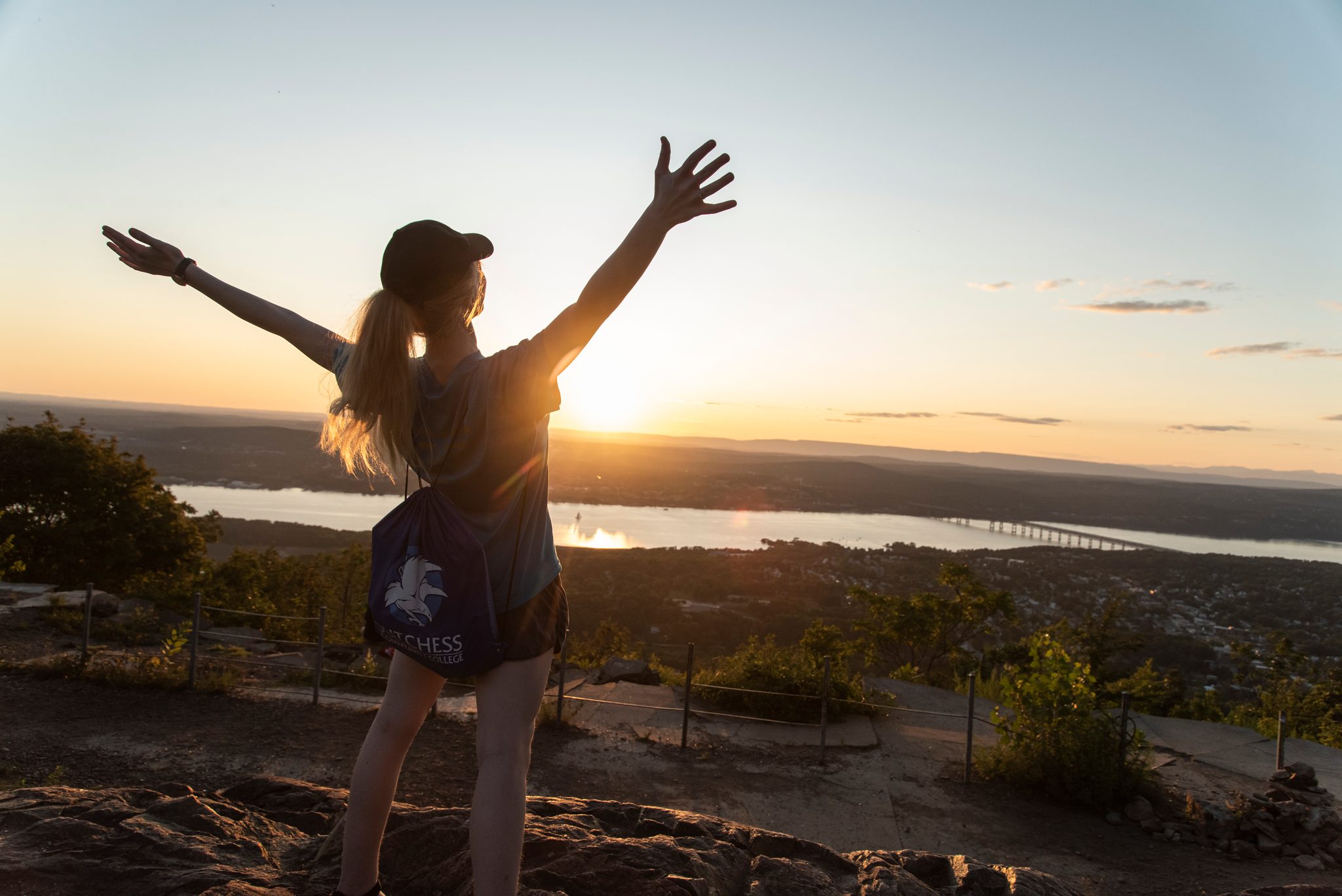 Arms flung open to the sunset, she has the whole valley to herself for a moment.