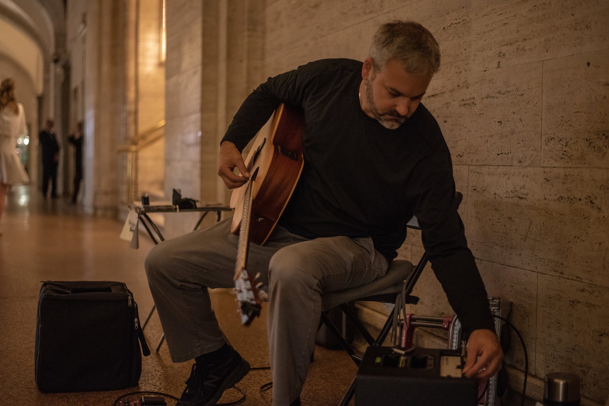 Crouched against the marble, Glenn adjusts a pedal before he starts.