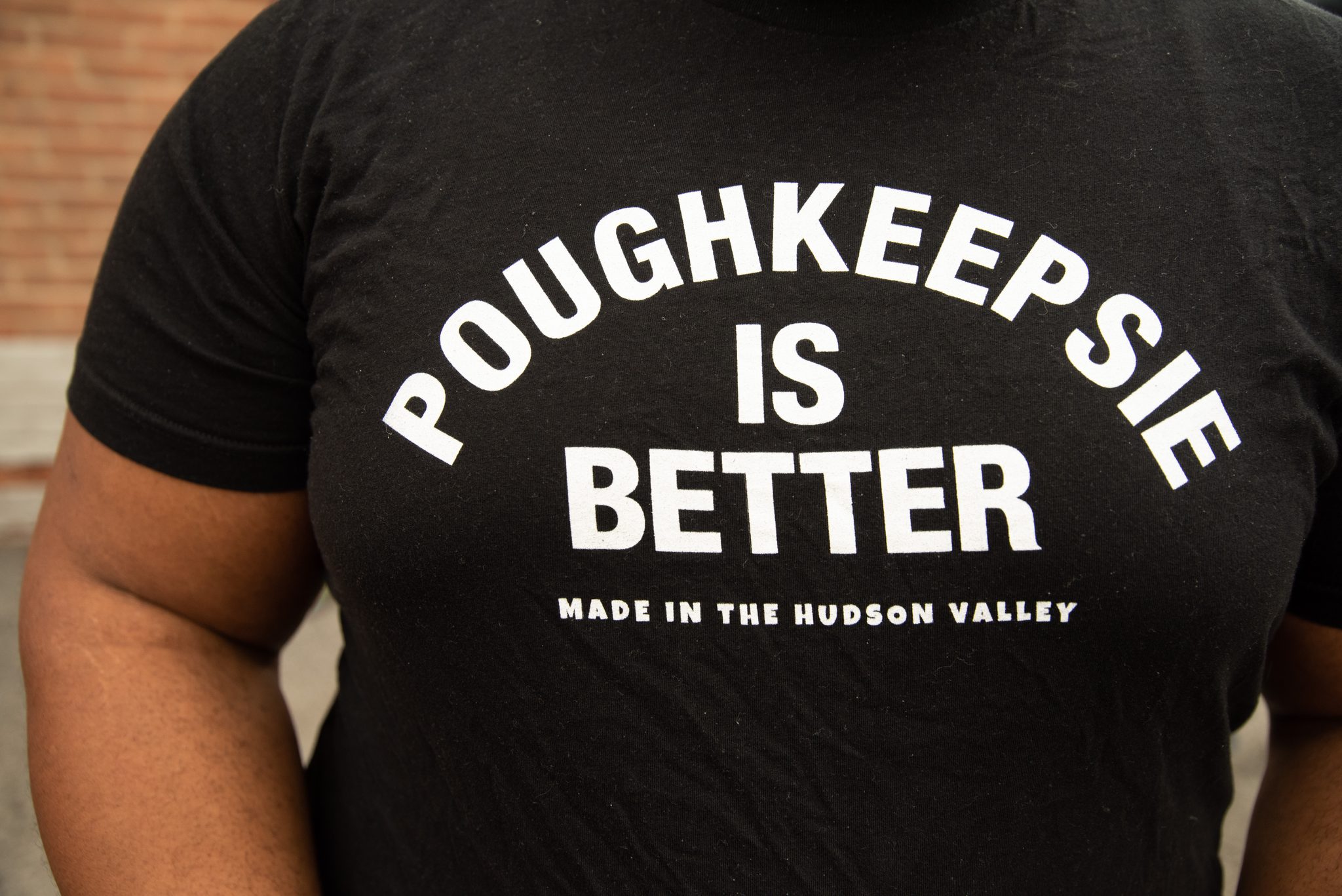 Poughkeepsie Is Better, across a volunteer's back.