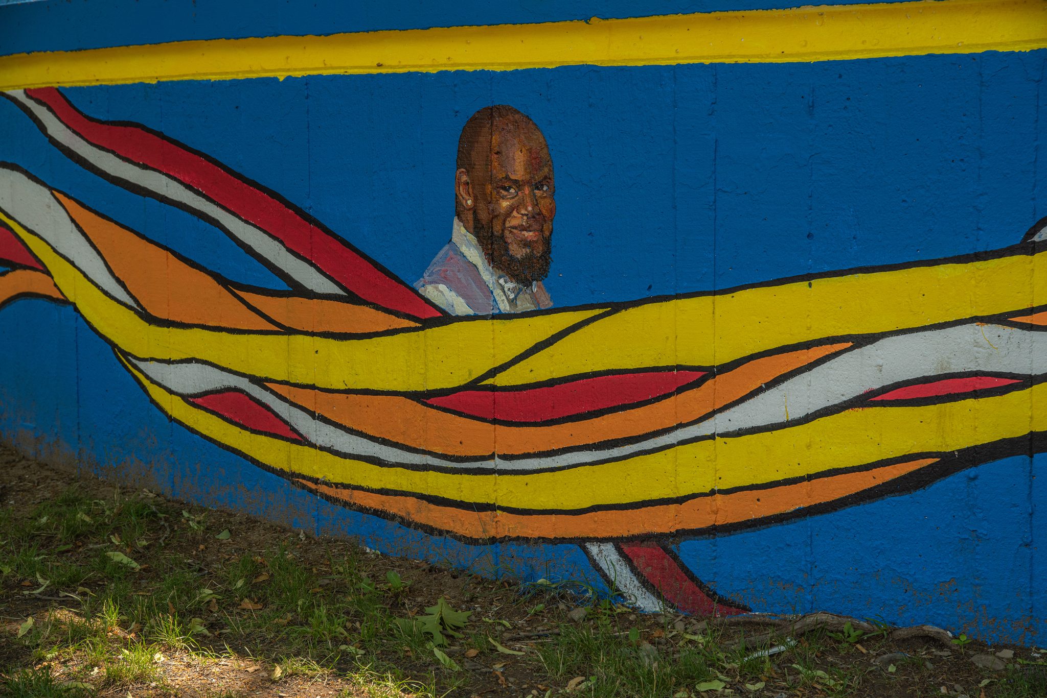A painted portrait watches over the park from the new mural.