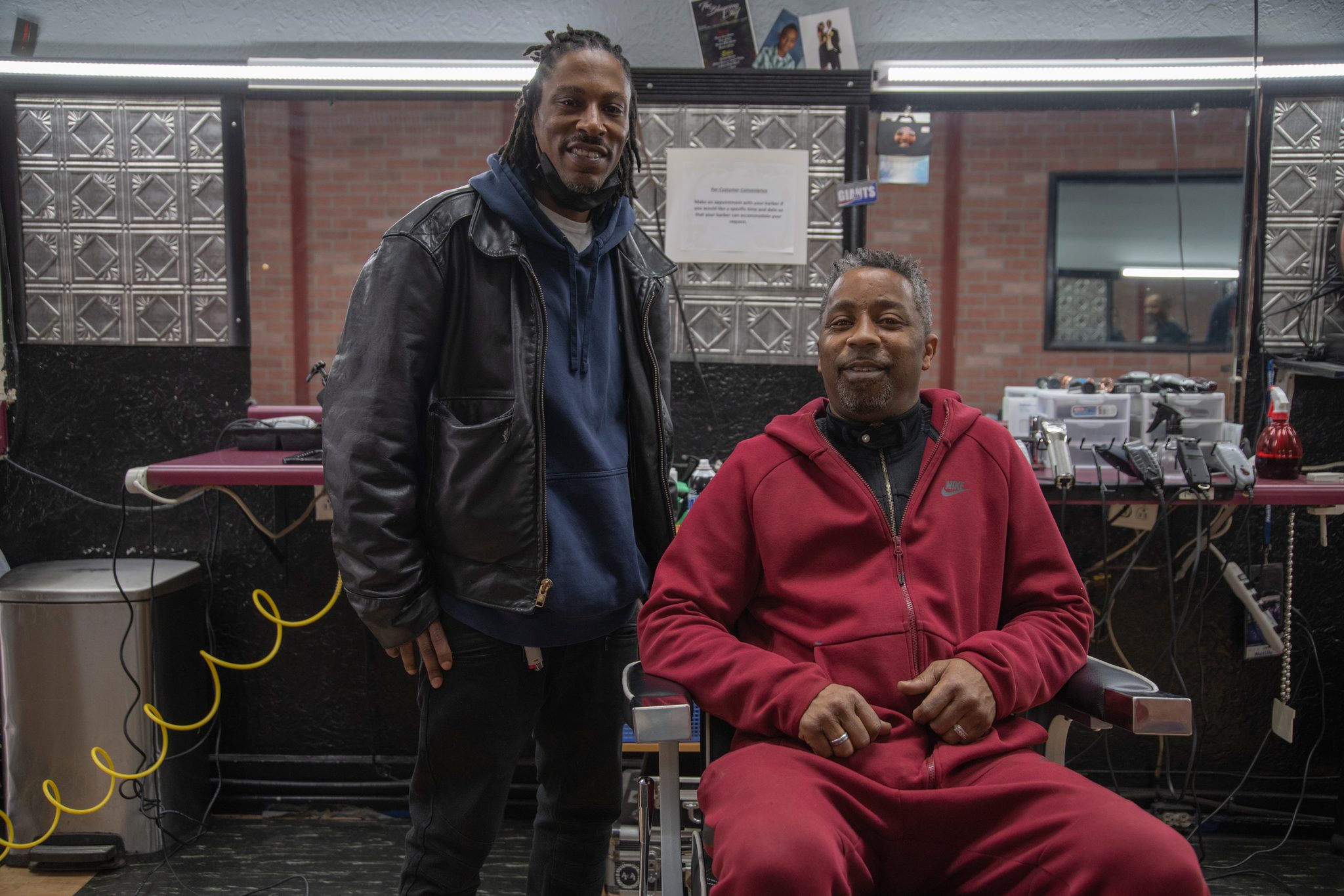 Two men talk it out in the barbershop.