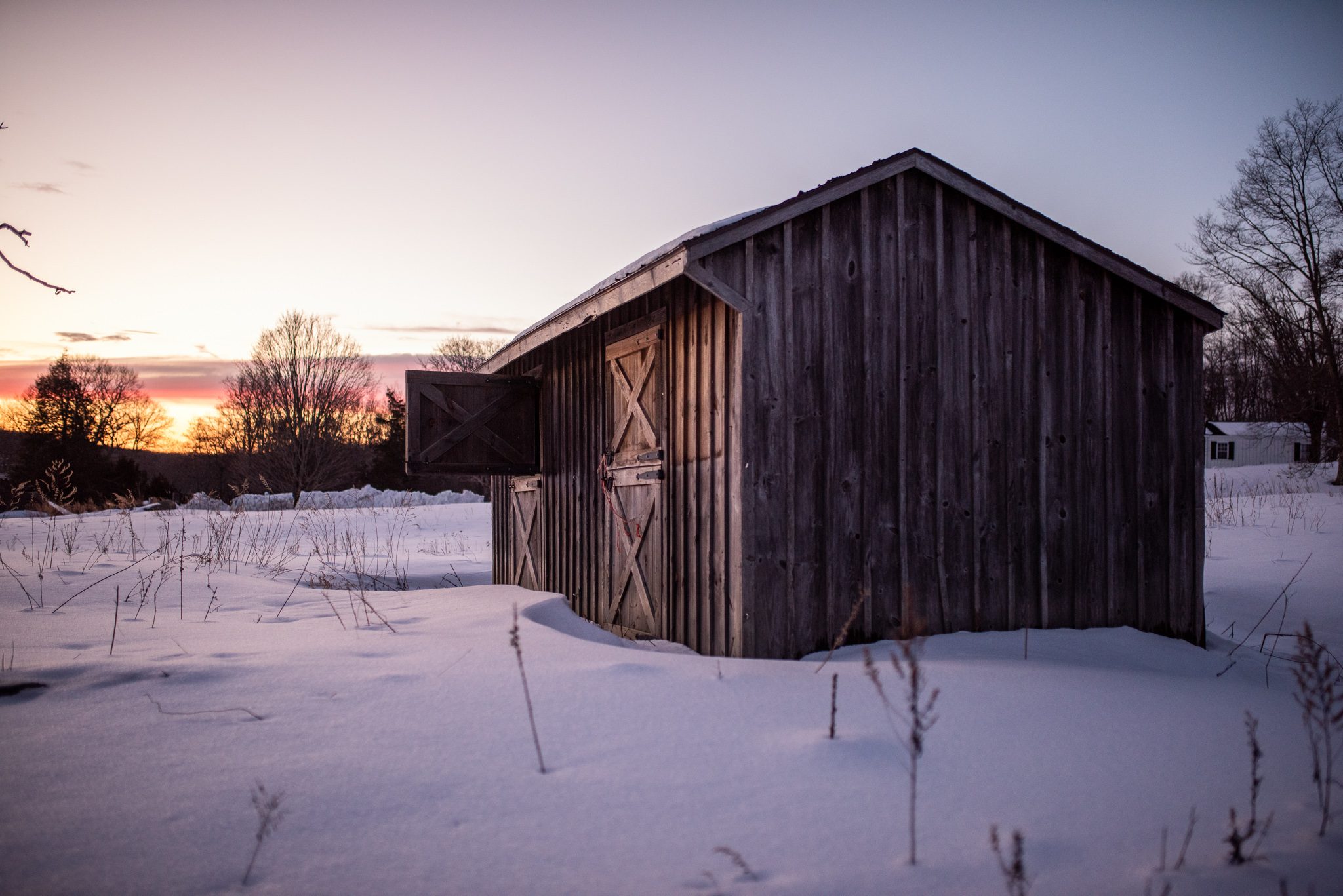 A weathered wooden shed holds the last of the sunset.