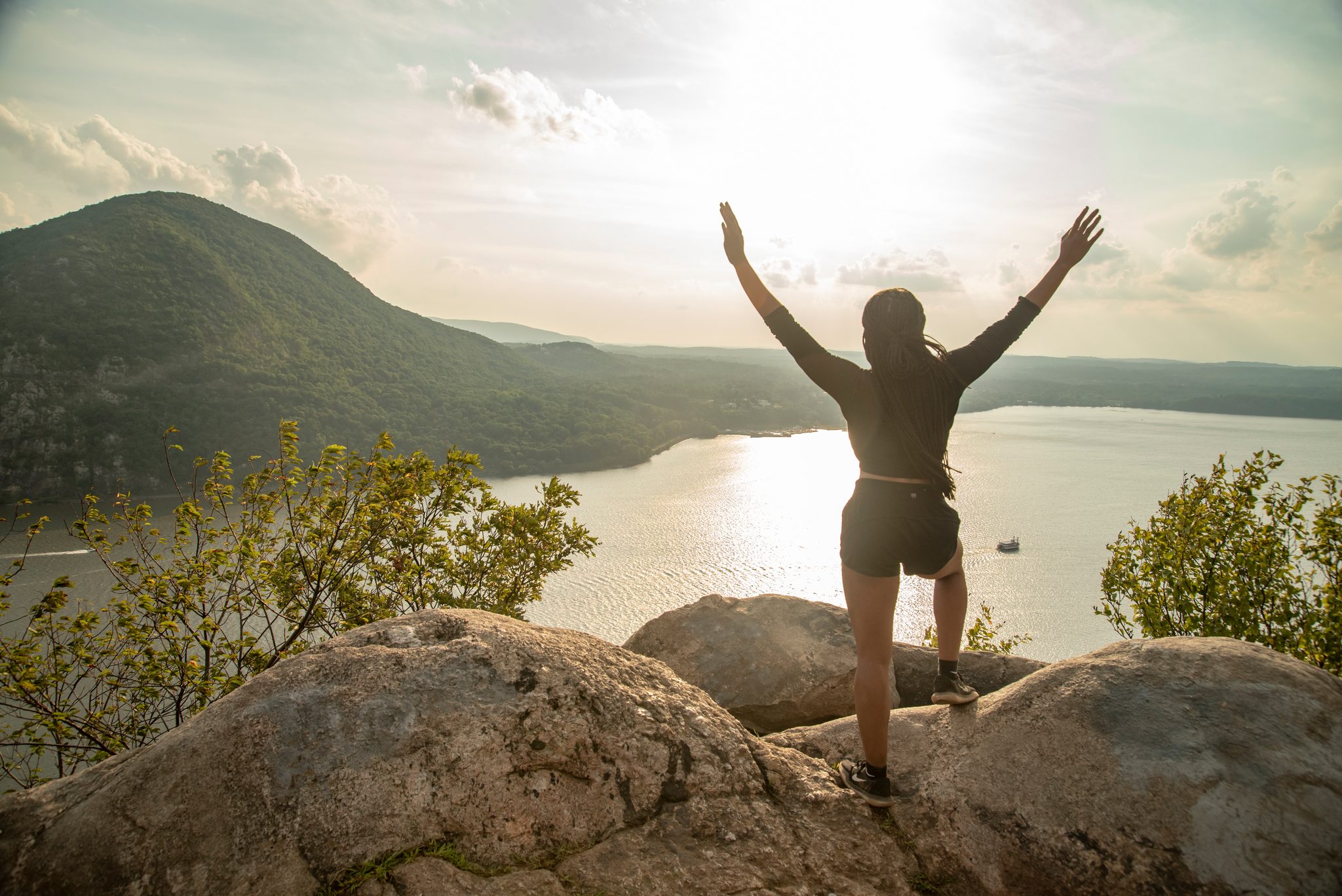 She turns her back on the trail and throws both arms open to the Hudson.