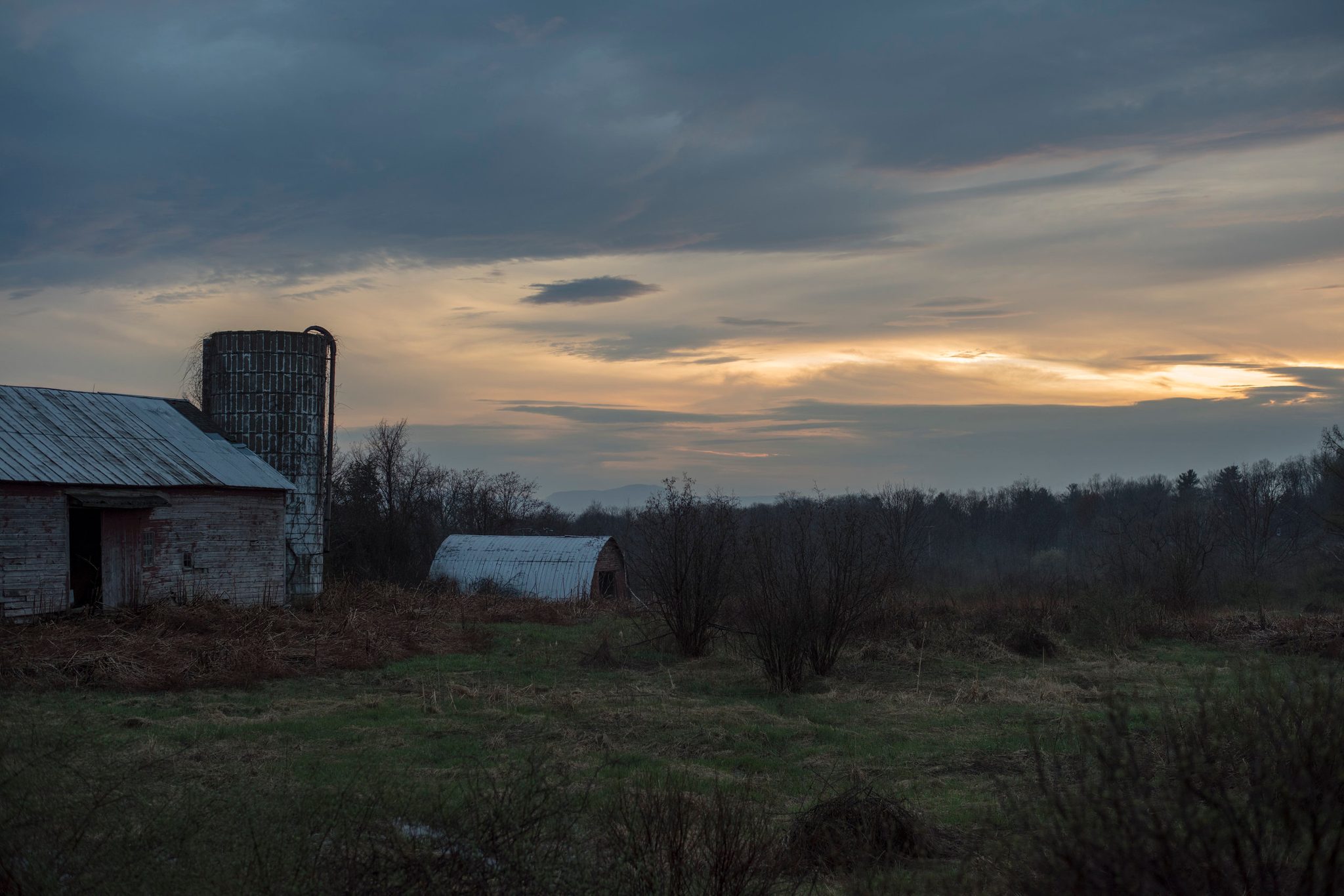 Clouds close over the old barn as the sun slips under them. What is all this tumult and toil worth if we cannot be still enough to watch the sun set?